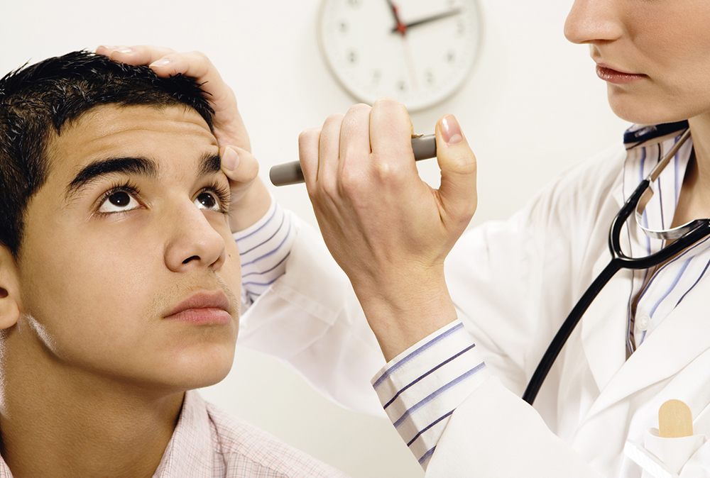 Young athlete being checked for a concussion