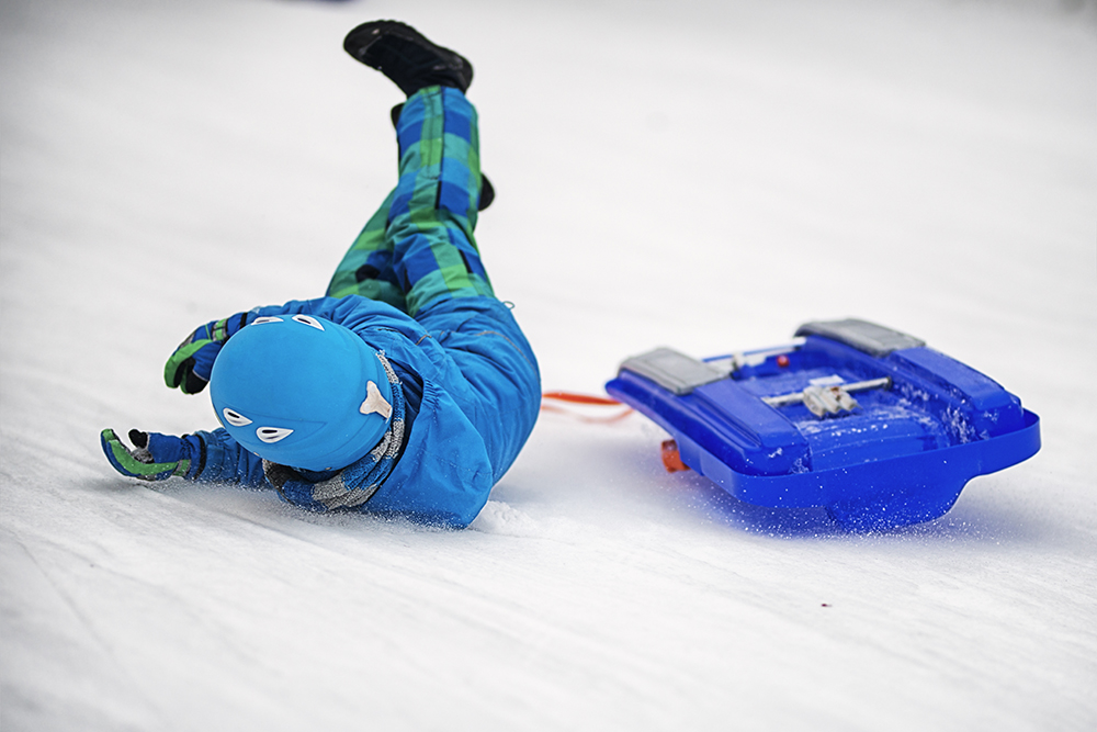 boy falling off sled